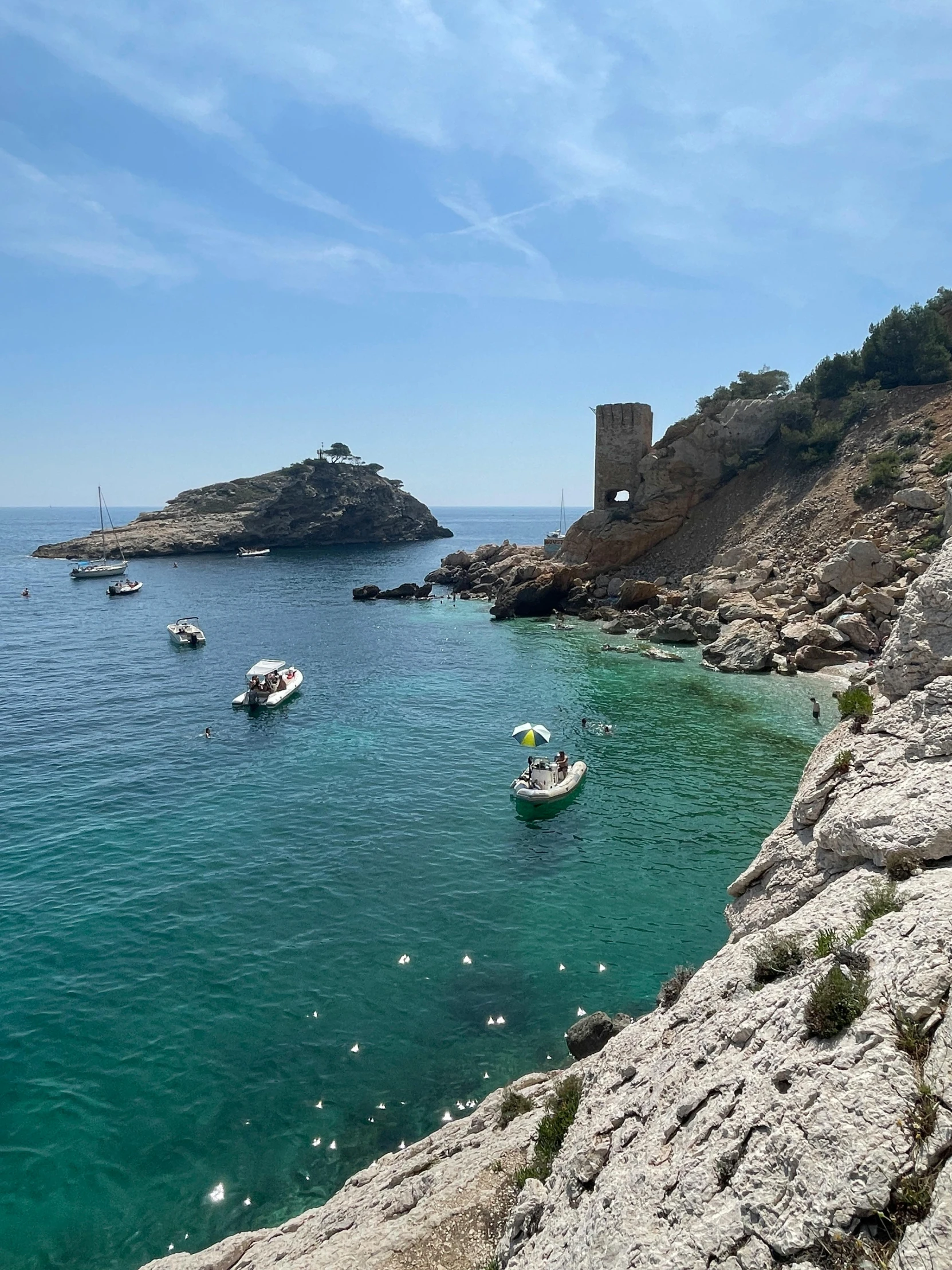 several boats in the water with the rocks on either side of it