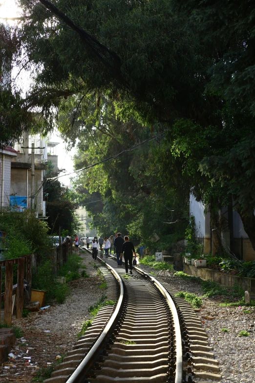 the railway tracks with two people walking on them