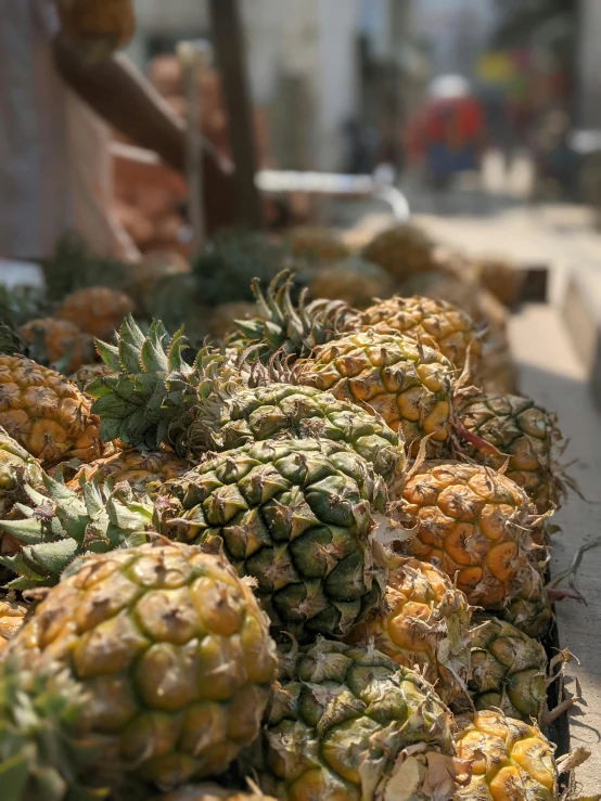 a pile of pineapples is shown on the street