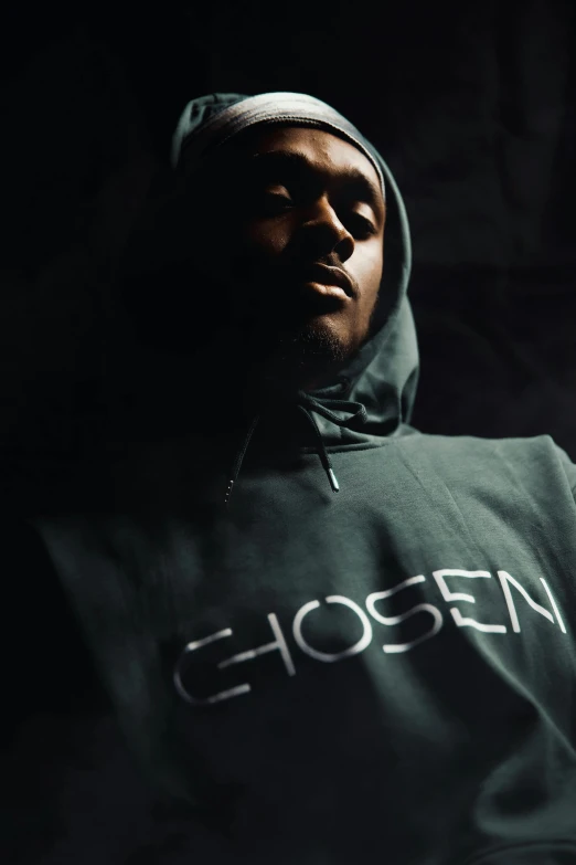 black man in green hoodie with ghosten on the front