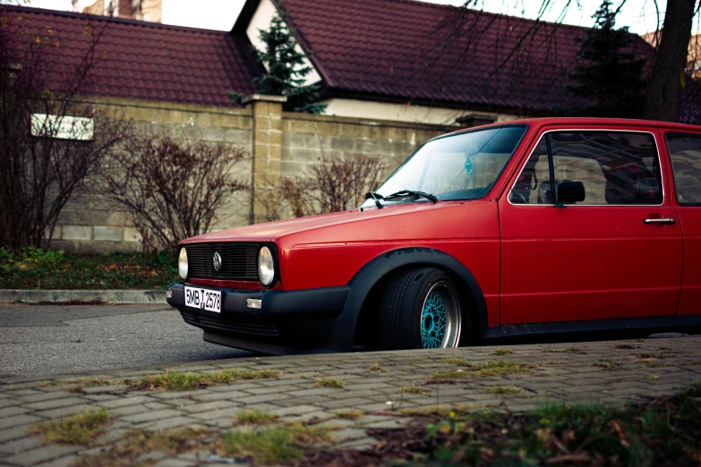 the red car is parked on the street