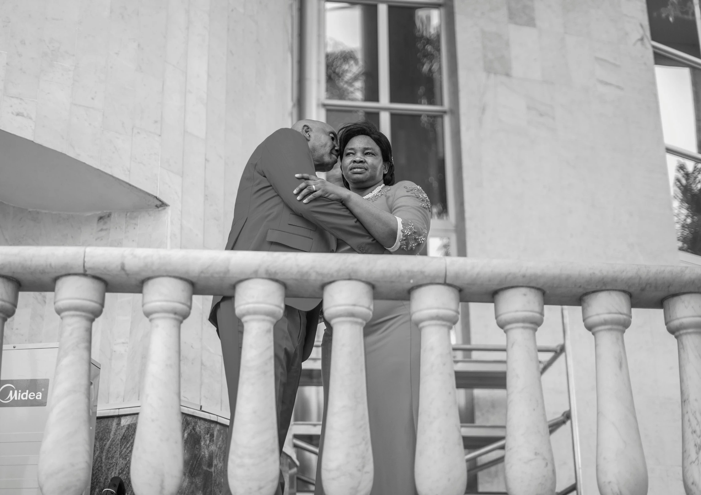 a man and woman standing on a balcony