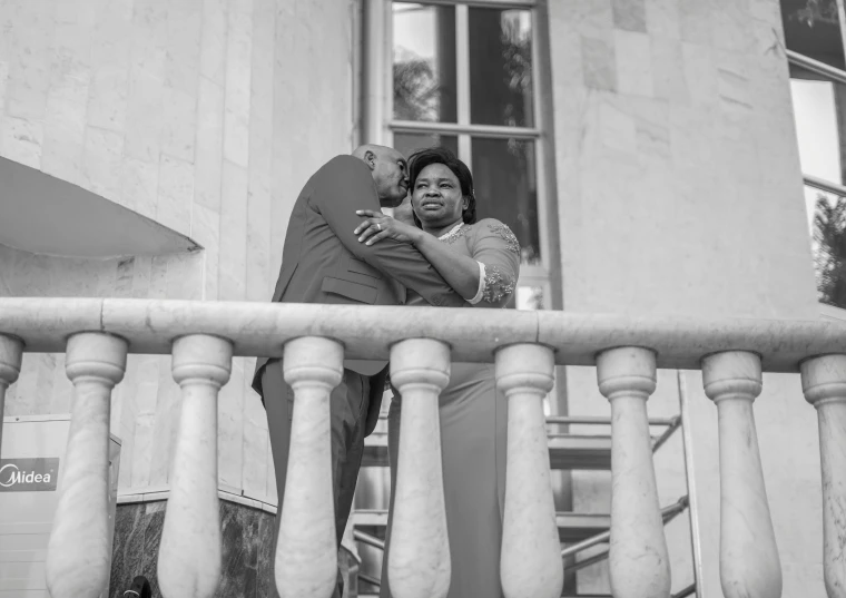 a man and woman standing on a balcony