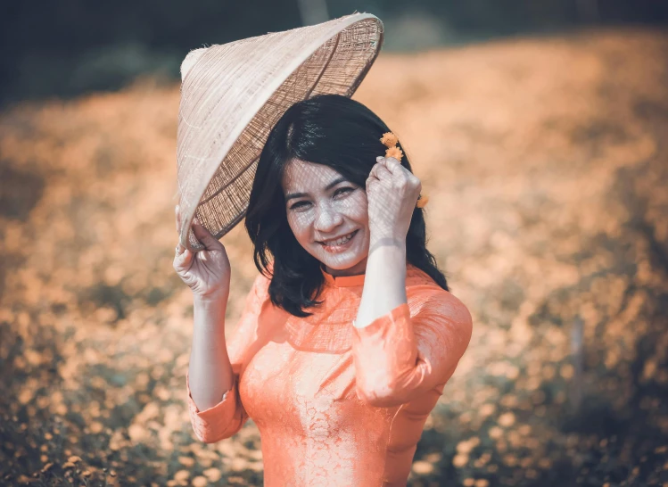 a woman with a straw hat in a field