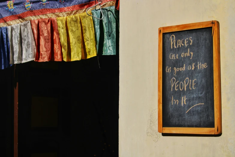 an old blackboard with a colorful streamer hanging in front