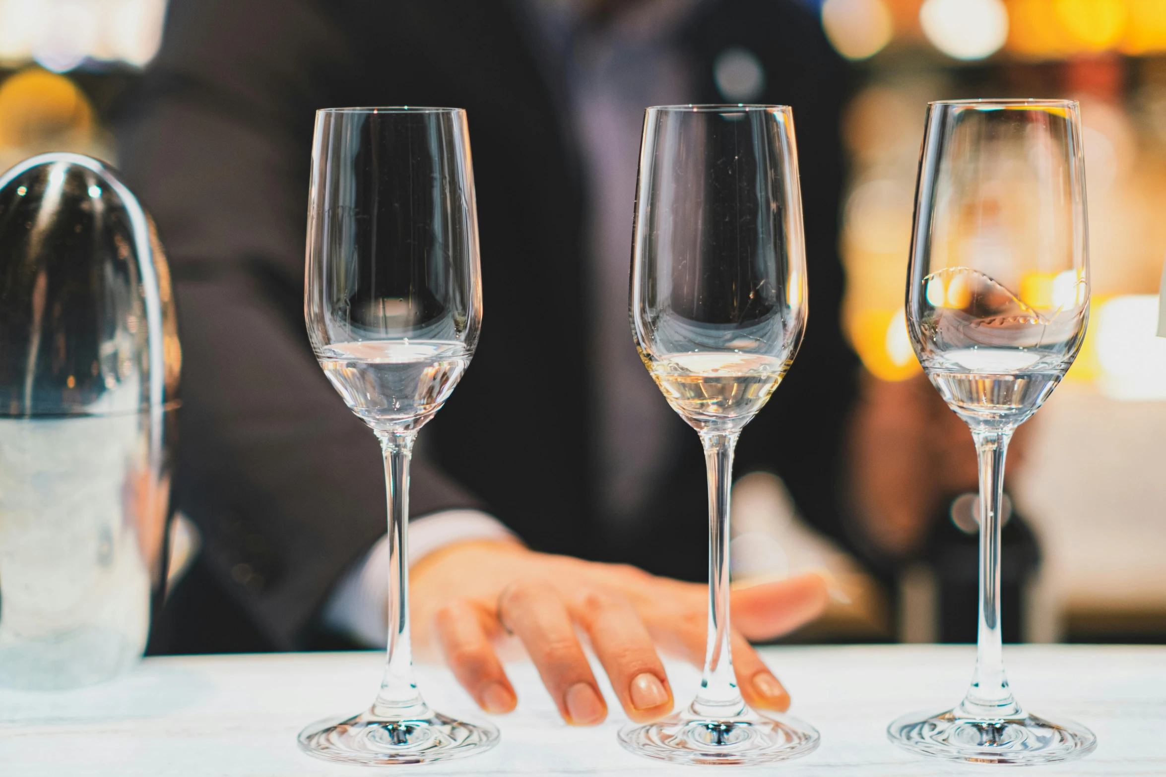 a close up of three wine glasses in a row