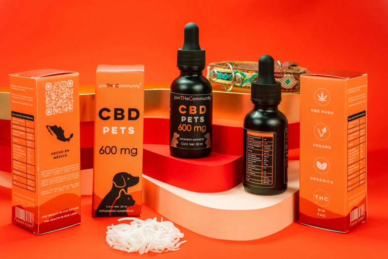 two bottles of cbd pets and an orange box of pills