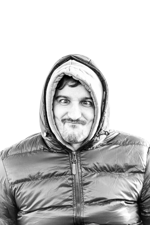 black and white image of a smiling man in a jacket