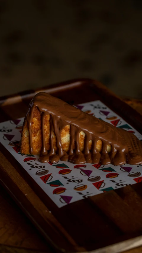 a piece of cake on top of a wooden serving tray