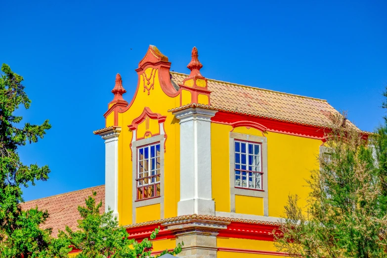 an old yellow building stands on a clear blue sky