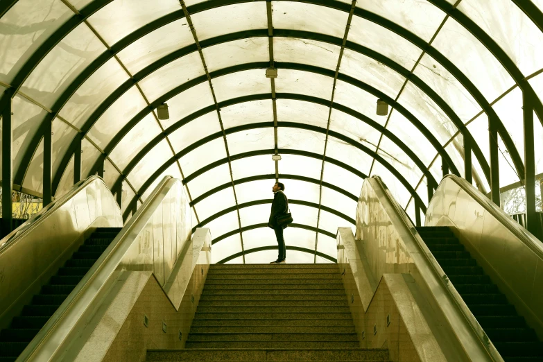 a person walking down a staircase way to another building