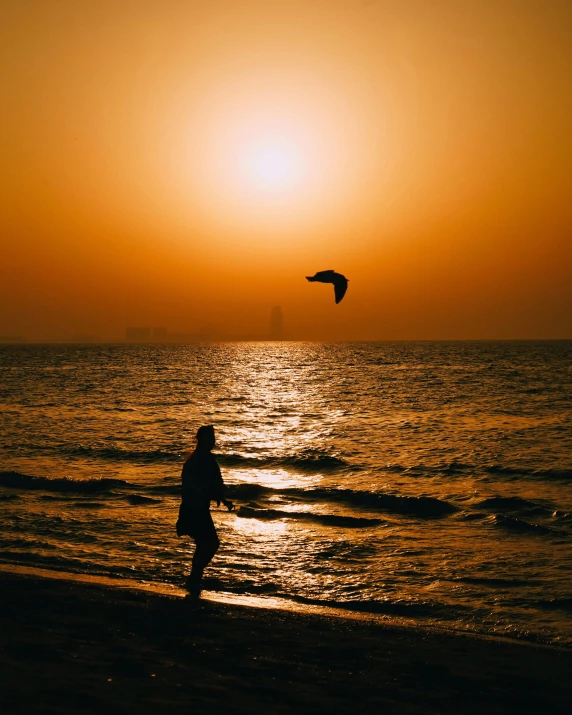 the sun is setting over the water at the beach