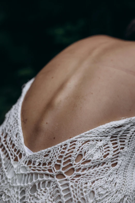 back view of a woman's white lacy blouse