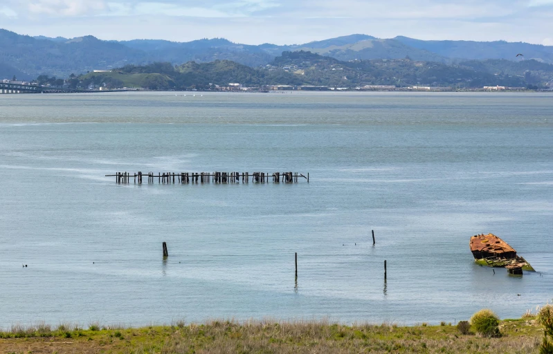 a view from the side of a small dock over water