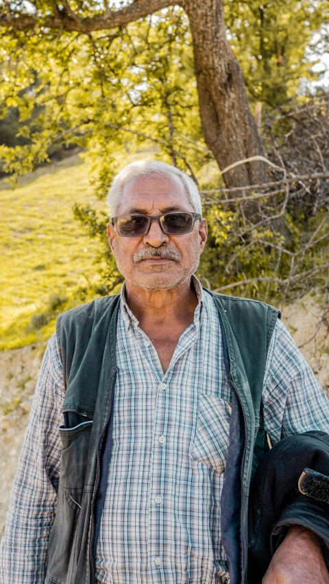 an older man with a backpack on and his feet crossed