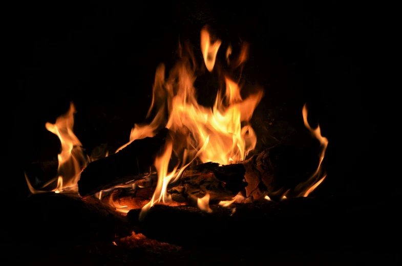 a very pretty fire in the dark on some rocks