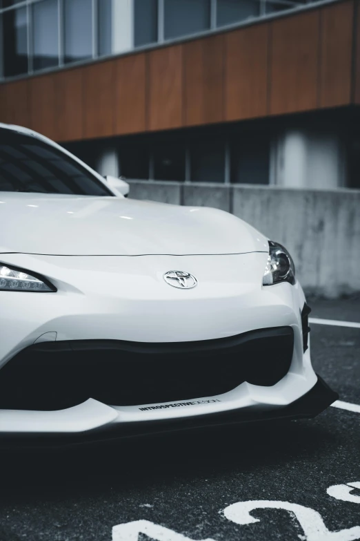 a white sports car sitting in a parking lot