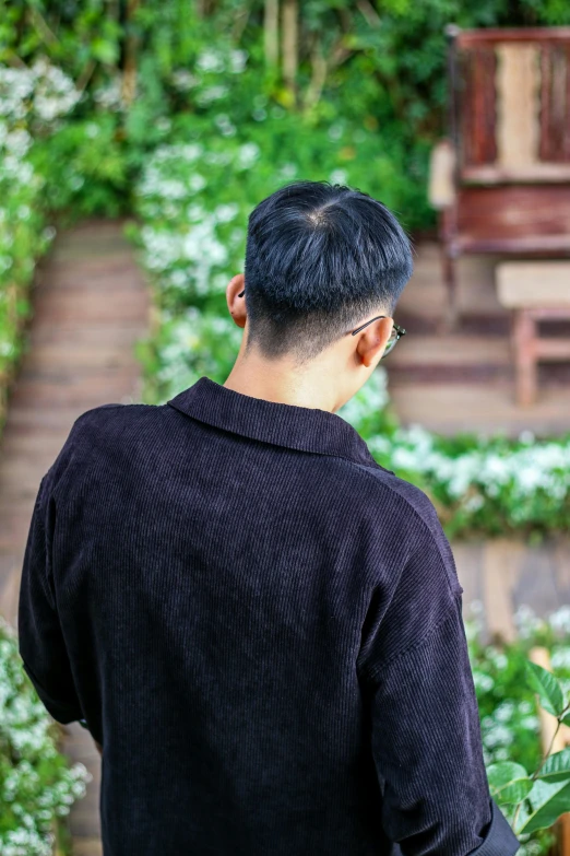 a man that is in the grass and some plants