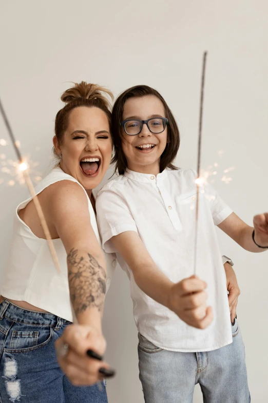 two people that are holding sparklers next to each other