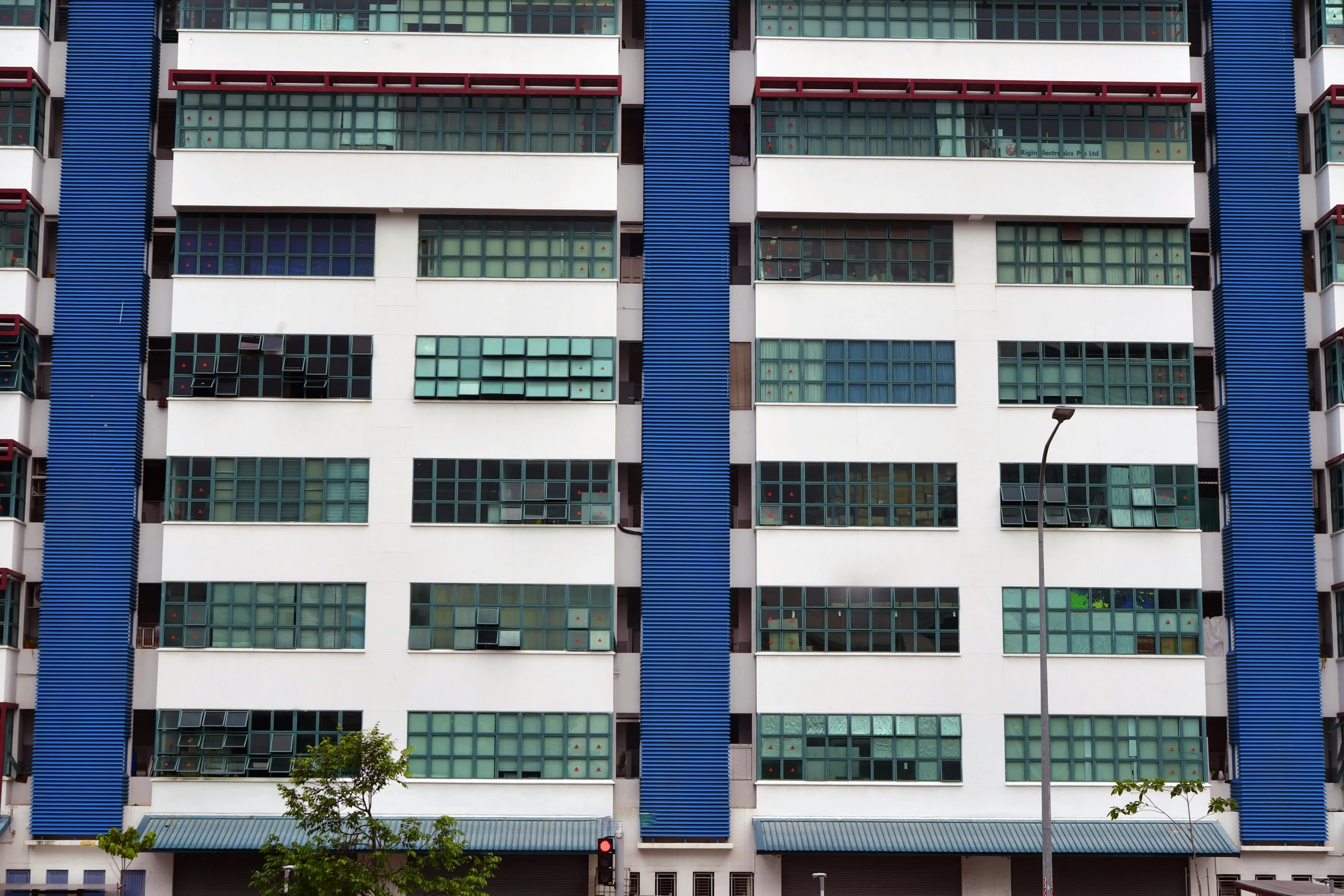 a tall white building with some blue lines on the side of it