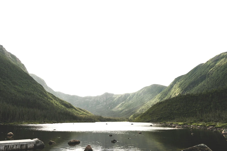 many rocks near some water and mountains