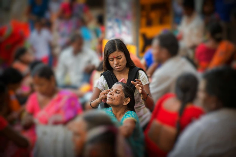 there is a woman being shown a hairpiece by a girl