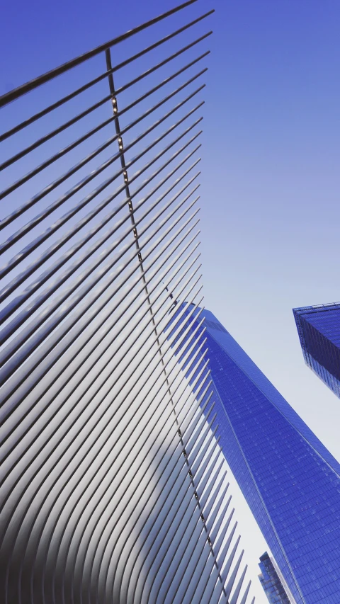 a sky view of two large buildings and one tall building