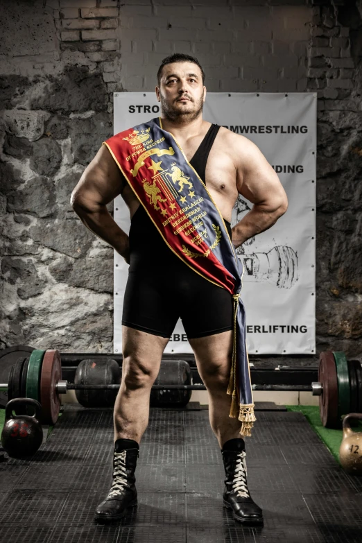 a man wearing wrestling clothes with an award on his head