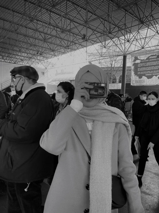 several people in a building with various items in their hands