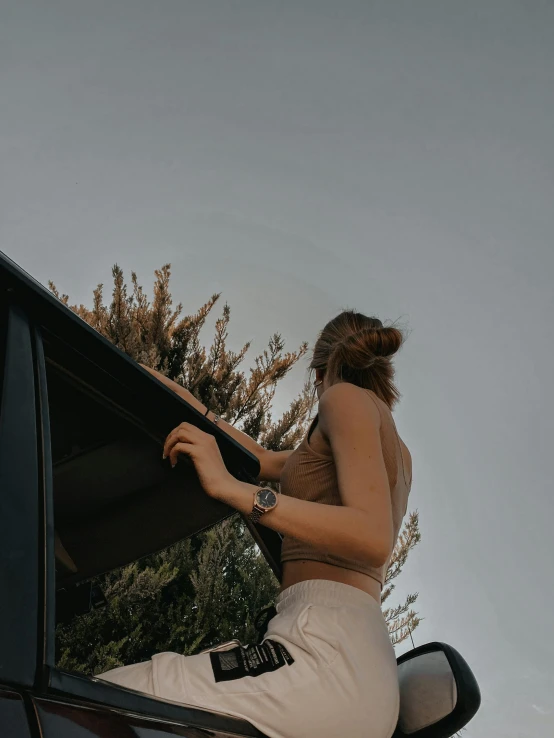 a woman sits on the back of her vehicle