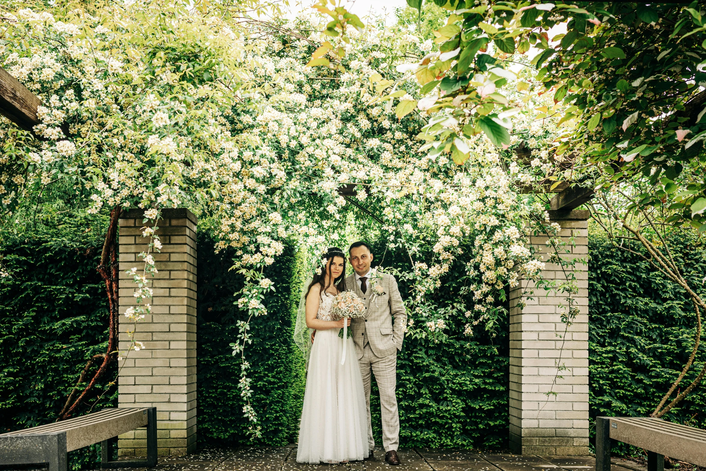 a bride and groom at their wedding in a garden