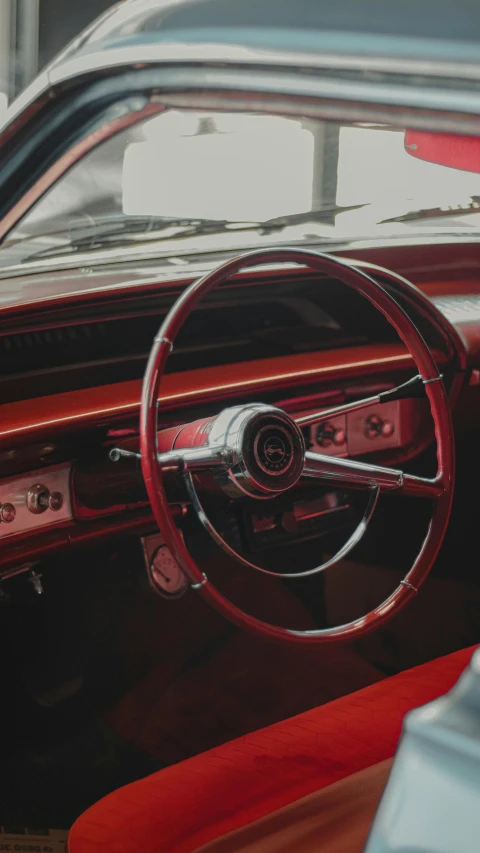 this old - fashioned car has been cleaned and is shiny red