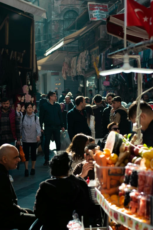 many people walking around with their luggage and drinks