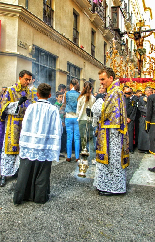 people dressed up wearing religious clothes in front of buildings