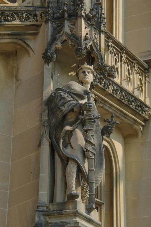 a statue in an old building with a tall tower