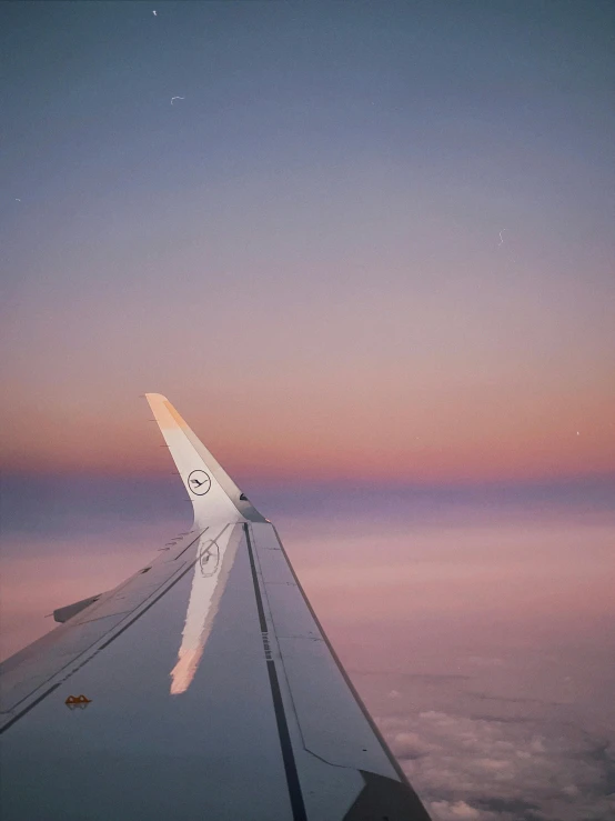 a view from inside an airplane flying over the clouds