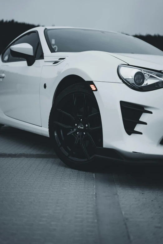 the white sports car has wheels that are black