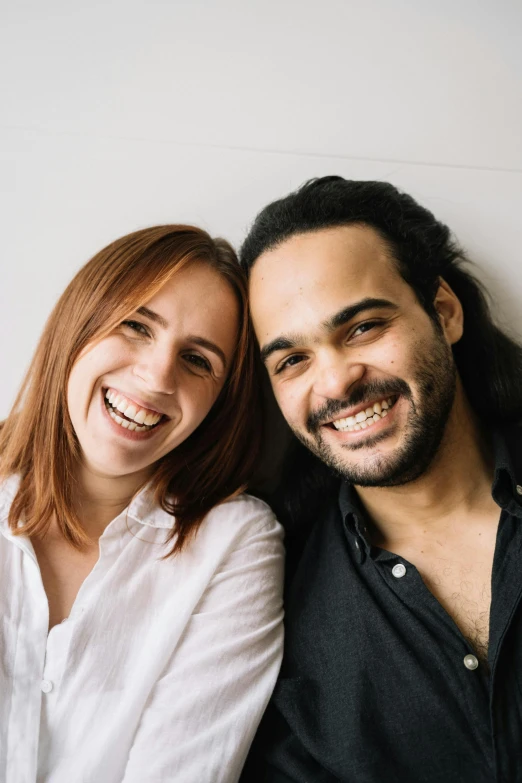 a smiling man and woman pose for a po