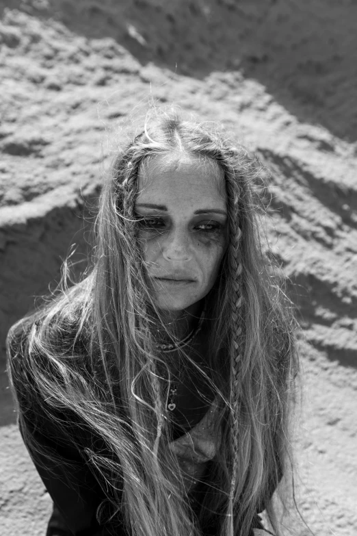 a woman with long hair is walking along a beach