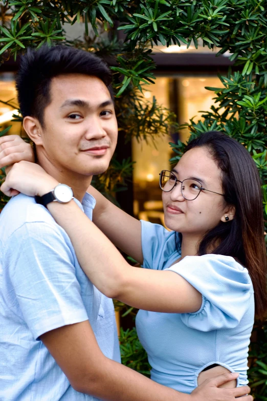 a young couple hugging and looking at each other