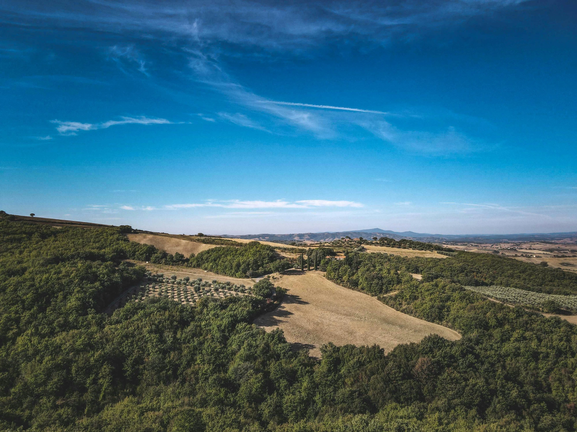 there is a beautiful blue sky and hills below