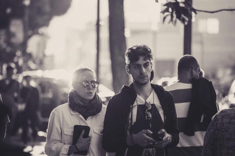 a man and woman are walking down a busy street