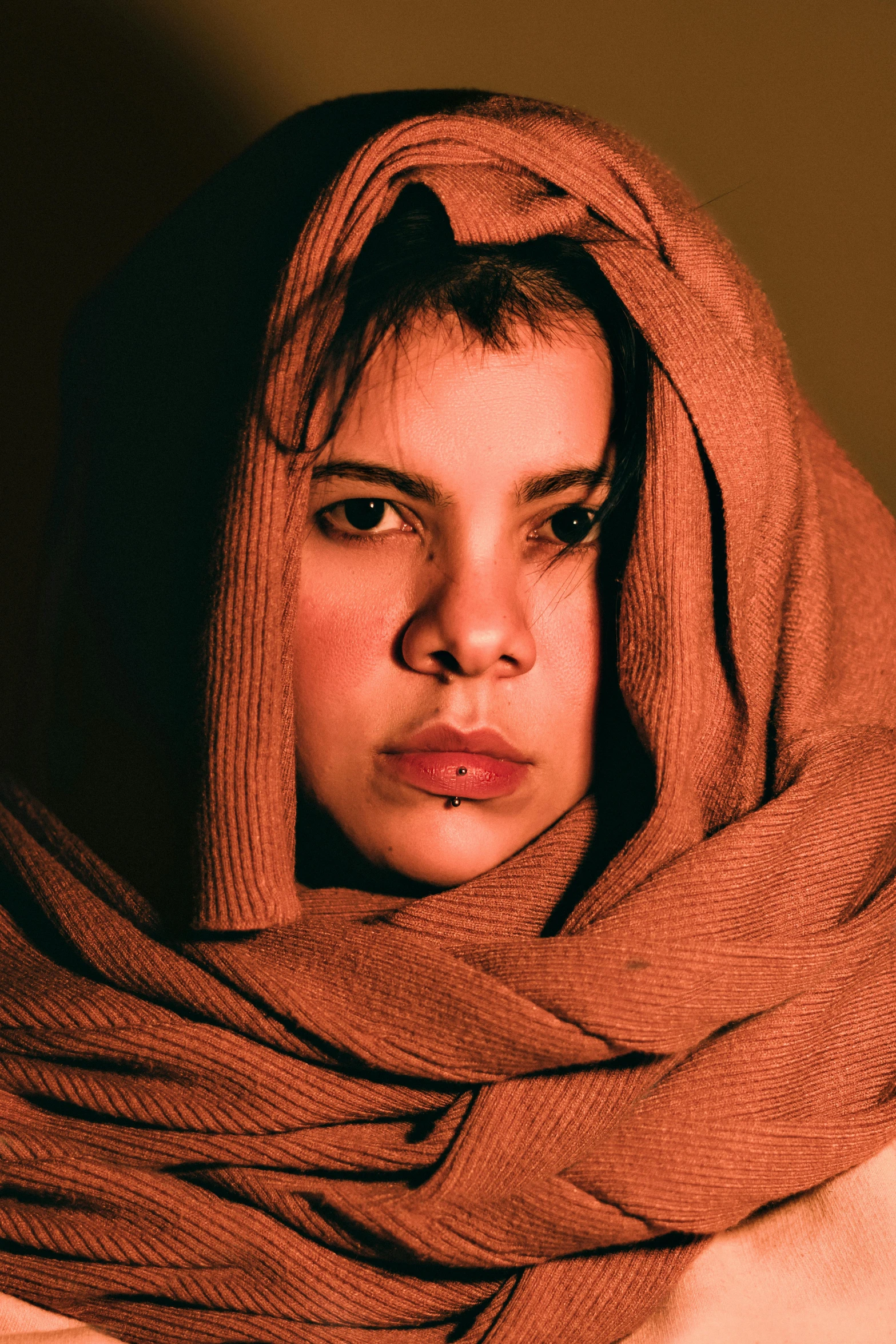 a woman in a red scarf looking to her right