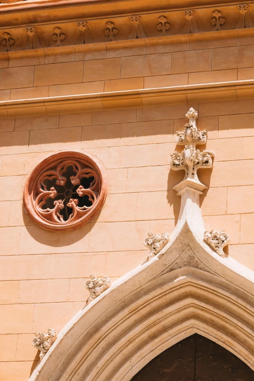 an archway has a decorative window above it