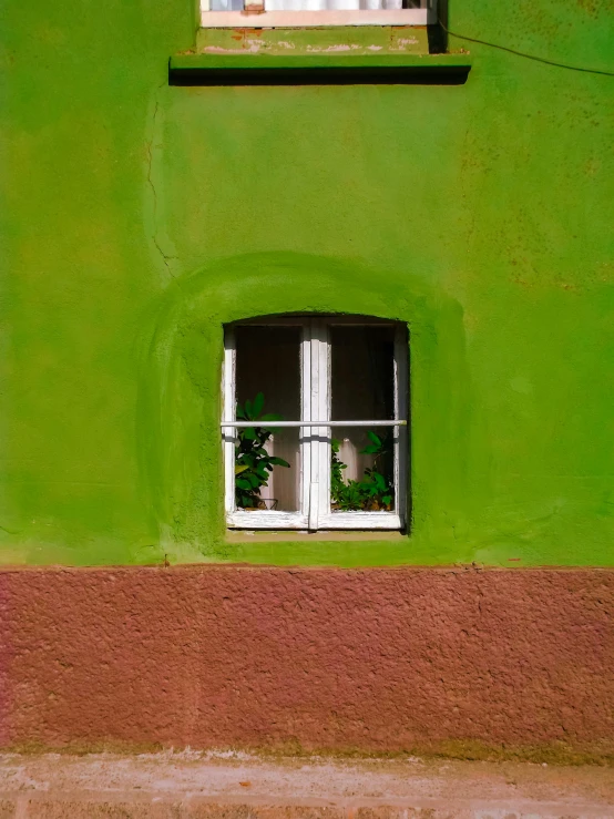 a white window on top of green building