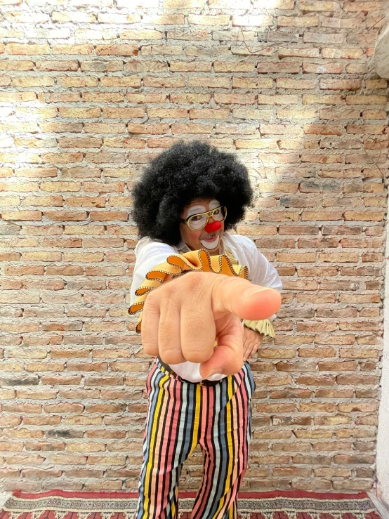 the clown is giving the finger to the camera