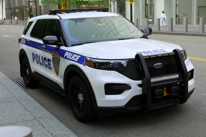 the police car is parked along a city street