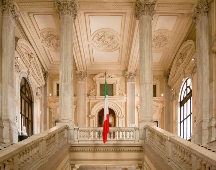 a person in red cloth standing on stairs with windows