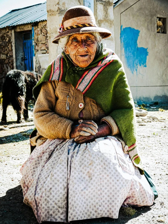 a woman in green jacket holding onto her teddy bear