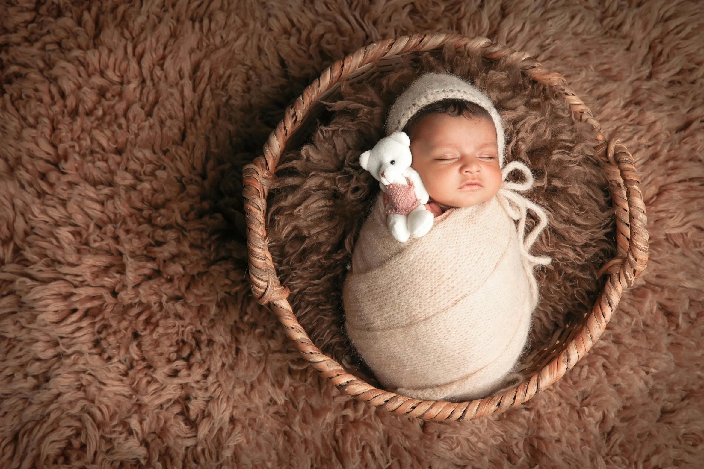 a newborn baby laying in a basket